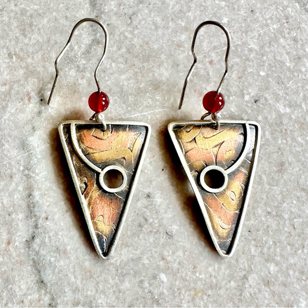 Mixed metal artisan dangle earrings with inventive ear wire to keep in place.